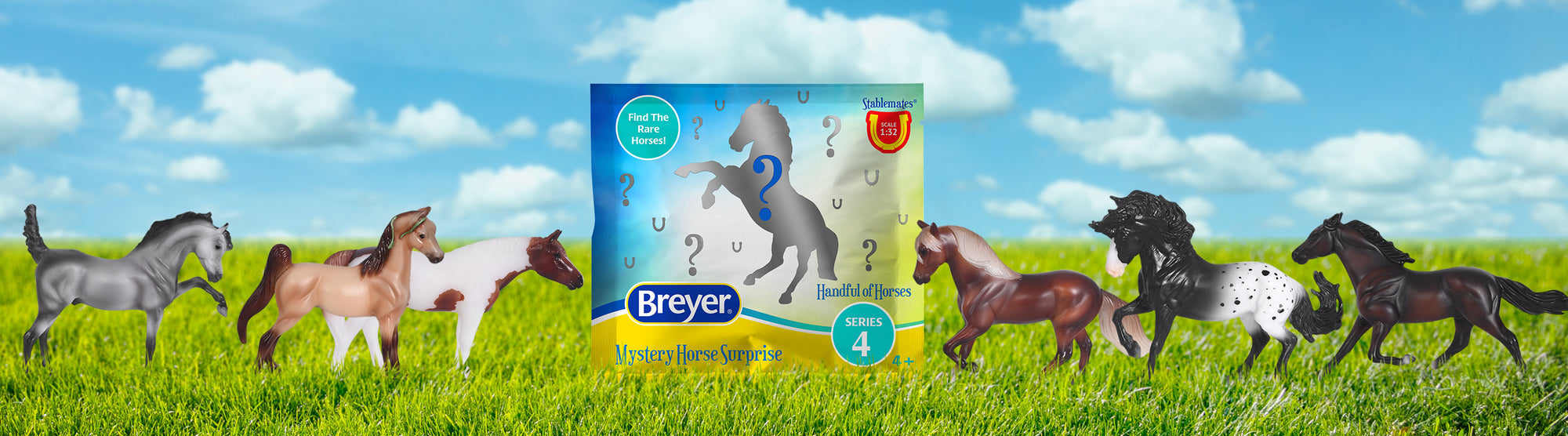 The packaging and models of a Breyer Surprise bag on a grassy setting