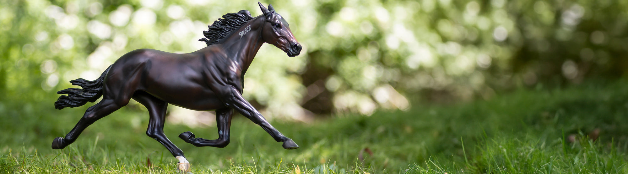 A Breyer Racehorse in the grass