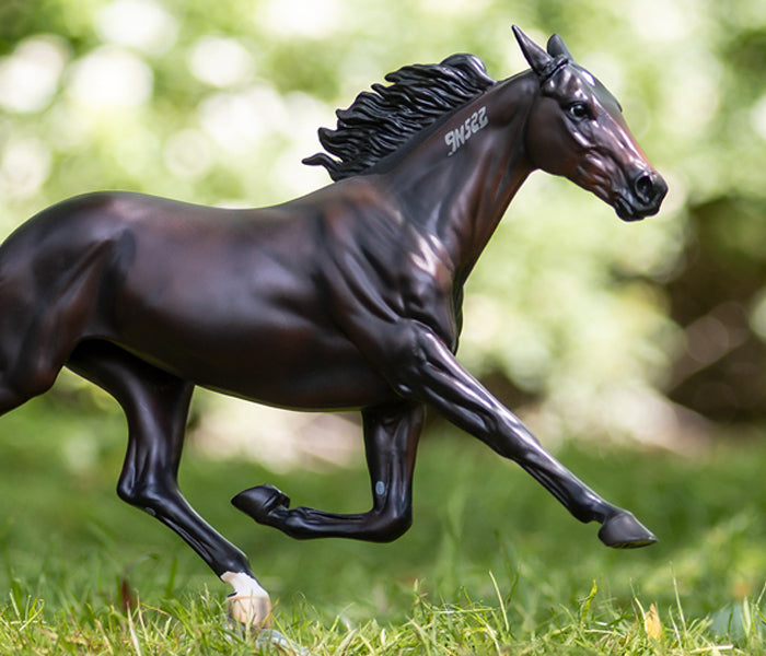 A Breyer Racehorse in the grass