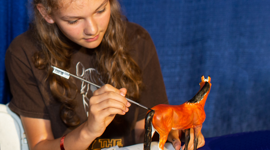 Go to Customizing and Creating - girl painting tail of model horse