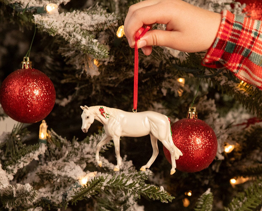 A child's hand displaying the American Quarter Horse | Beautiful Breeds Ornament