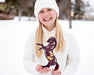 A child holding Auryn | Freedom Series Unicorn outside in the snow