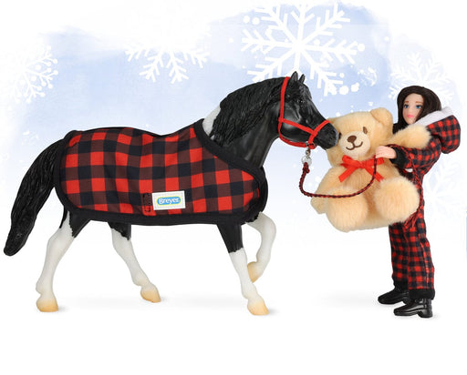 Holiday Pajama Party with Cinders, a tobiano pinto pony wearing buffalo plaid blanket, Christy in buffalo plaid pjs, and teddy bear