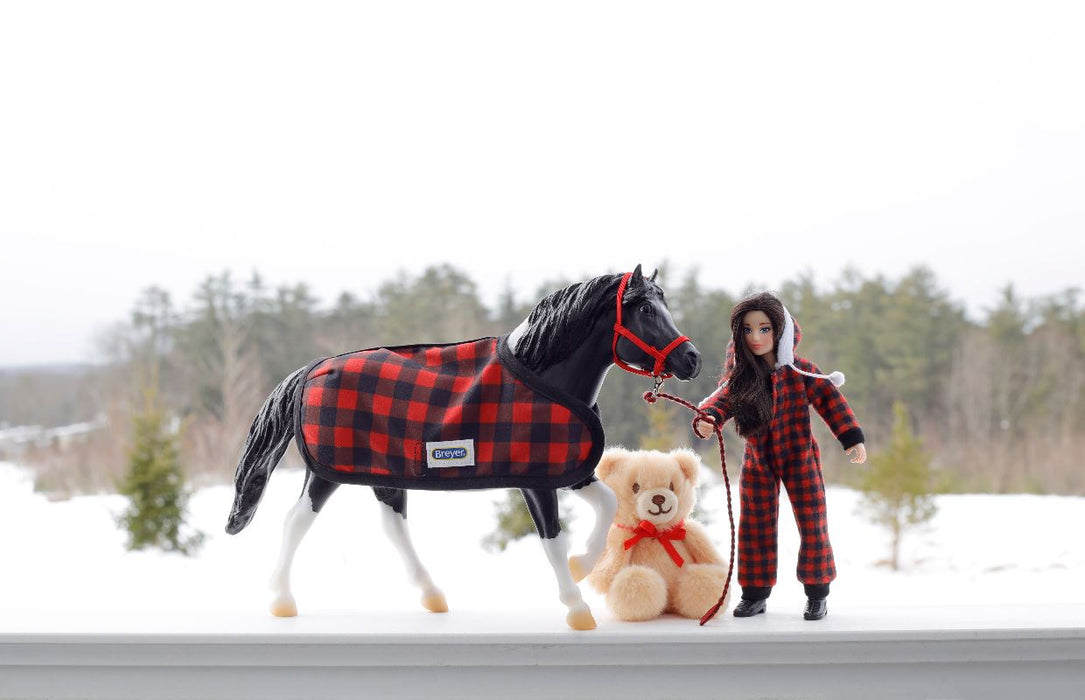 Holiday Pajama Party with Cinders, a tobiano pinto pony wearing buffalo plaid blanket, Christy in buffalo plaid pjs, and teddy bear