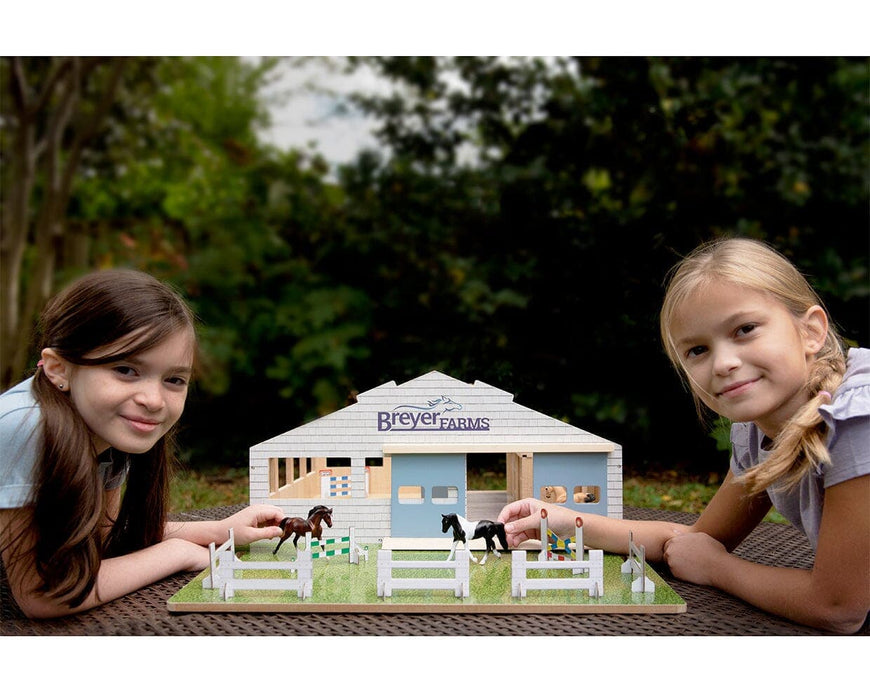 Two girls playing with The Deluxe Arena Stable