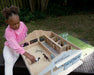 A girl playing with The Deluxe Arena Stable