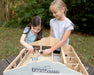 Two girls playing with the Deluxe Arena Stable - with the roof off