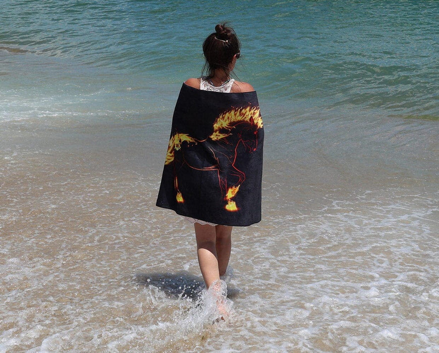 Fireheart Beach & Bath Towel on a person at the beach