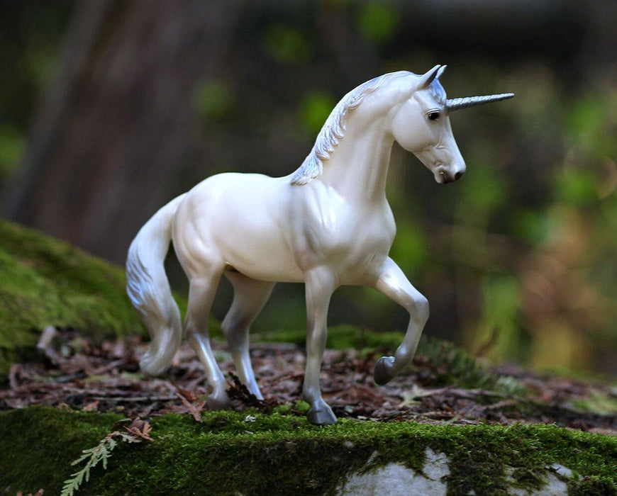 Lysander standing on a moss covered rock, facing right