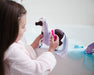 A girl playing with Marina Color Change Mer-Pony near on a bathtub with the atomizer bottle