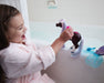 A girl playing with Marina Color Change Mer-Pony near on a bathtub