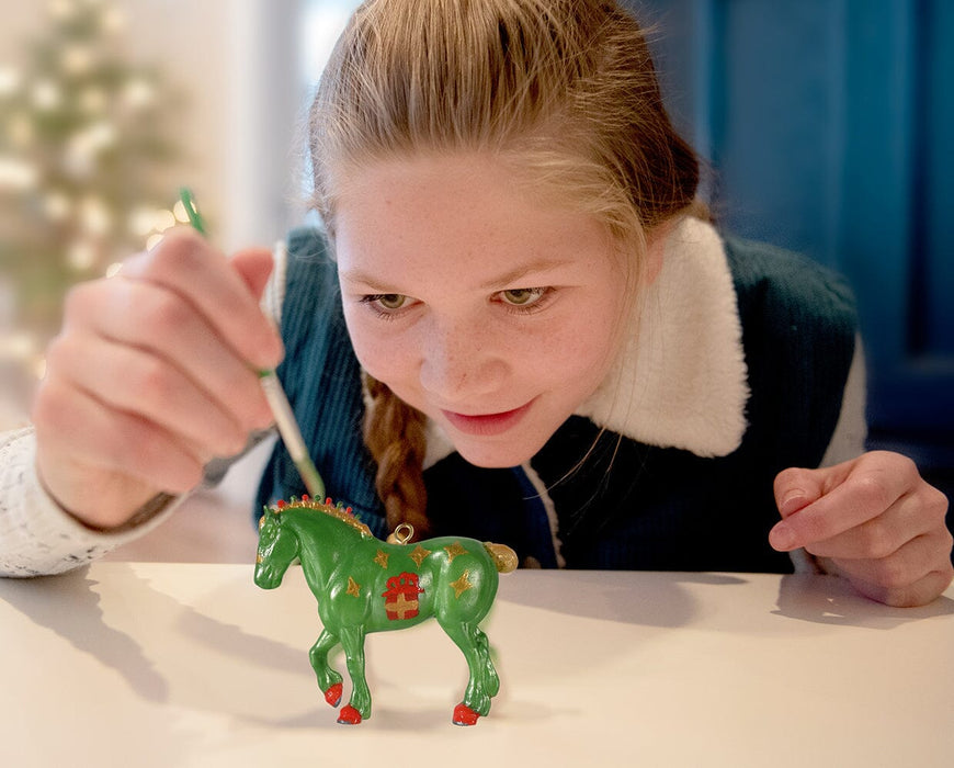 A girl painting the Paint Your Horse | Ornament Craft Kit