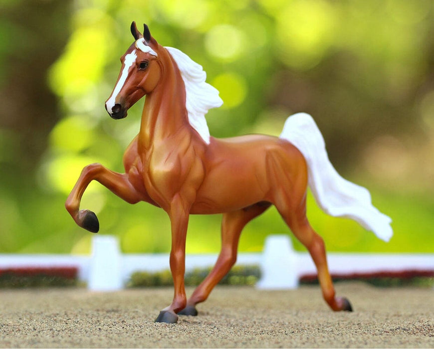 Palomino Saddlebred in an outdoor arena setting facing left