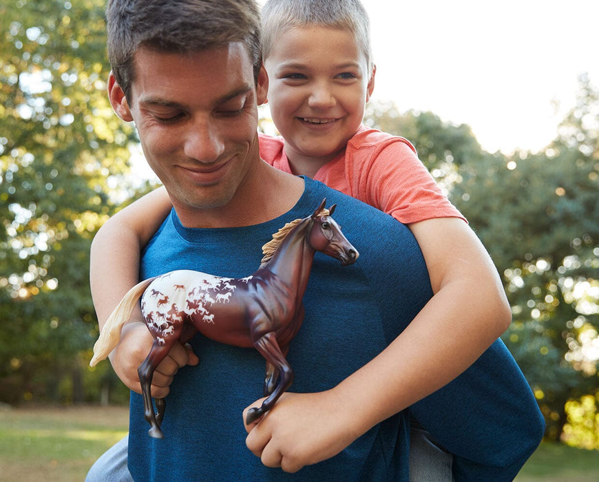 Sport Horse | Breyer 75th Anniversary - a child holding the model with adult