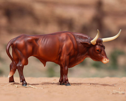 Texas Longhorn Bull | Breyer Animals facing right on a desert background