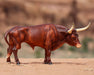 Texas Longhorn Bull | Breyer Animals facing right on a desert background