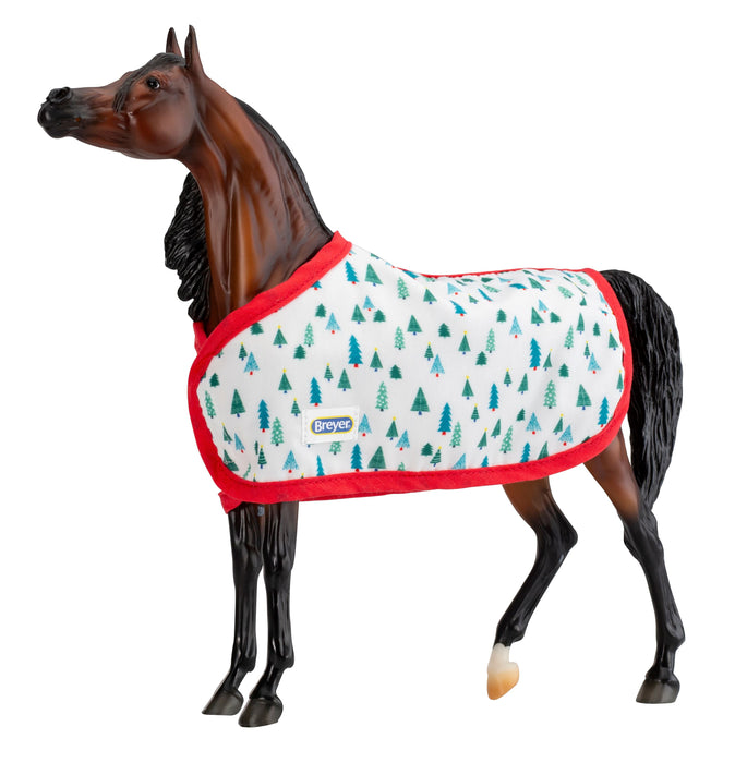 Traditional Holiday Horse Blanket; brown horse wearing blanket with green trees on white with red trim