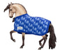 Traditional Holiday Horse Blanket; buckskin horse wearing blanket with blue trees with blue trim