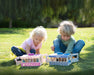 Two children playing with Breyer Carry Stables