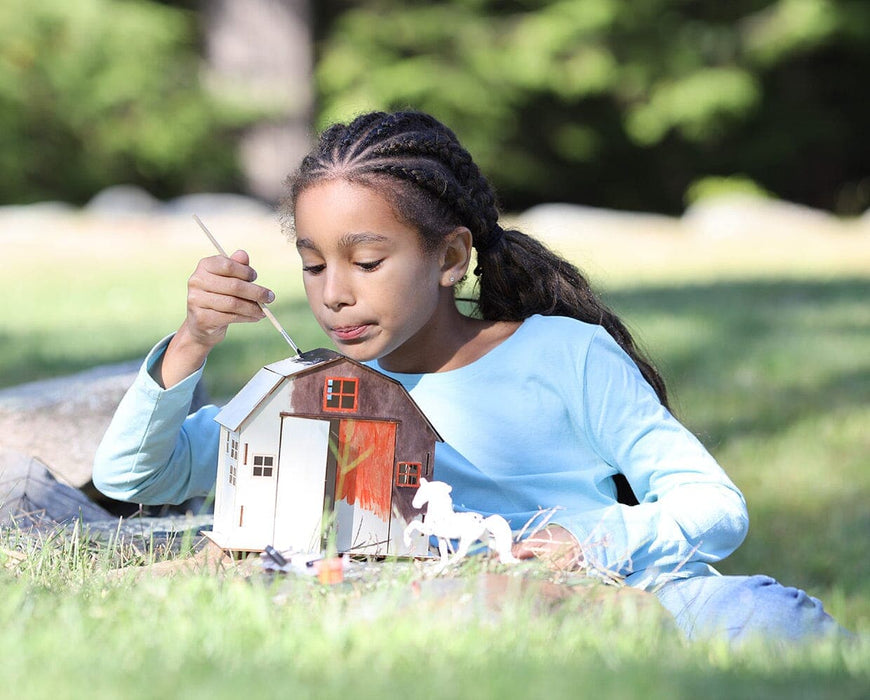 a girl painting the Horse & Barn Paint & Play outside