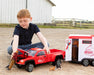 A boy with the Traditional Series "Dually" Truck and Trailer